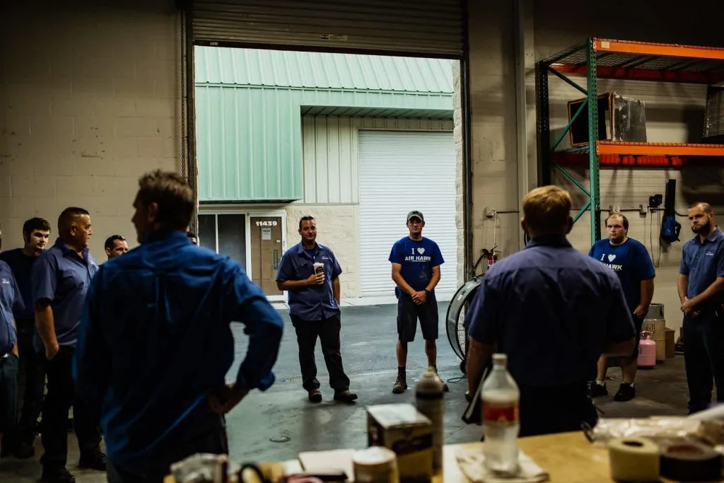 HVAC team huddle meeting at warehouse