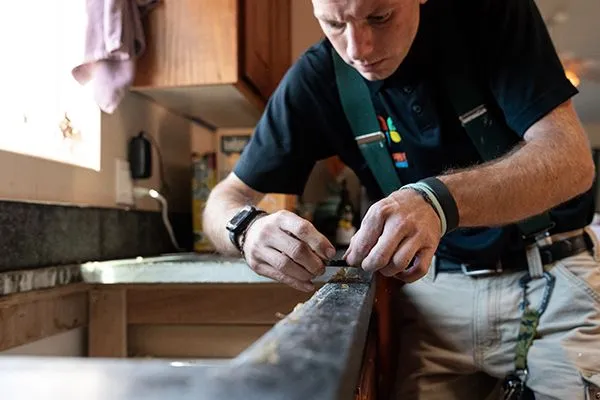 handyman working on kitchen counter