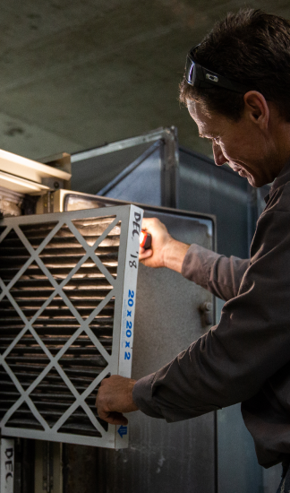 HVAC Pro replacing an air filter.