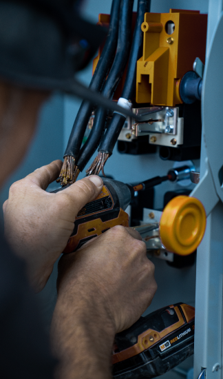 Electrician working with wiring and equipment.