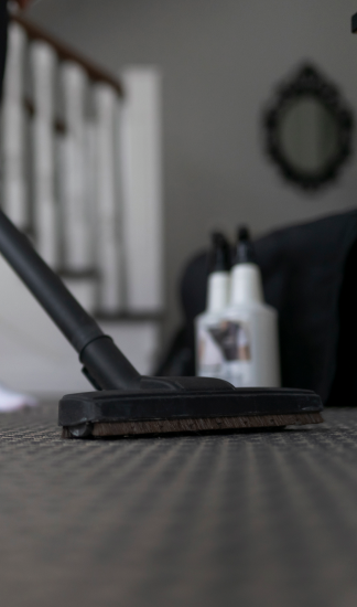 Vacuum cleaner on a carpet for cleaning services.